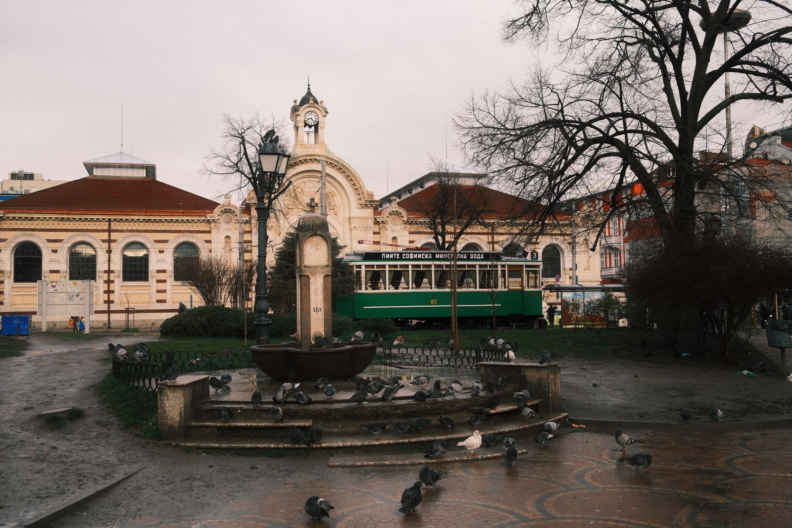 A vintage tram passing the historic Central Market Hall in Sofia